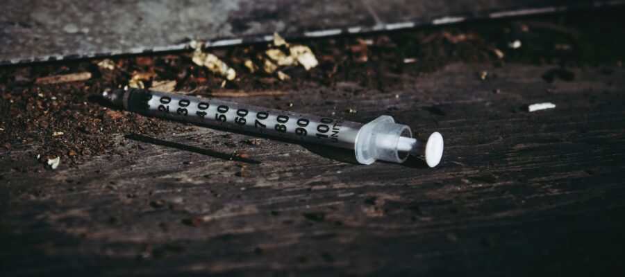 syringe on wooden floor