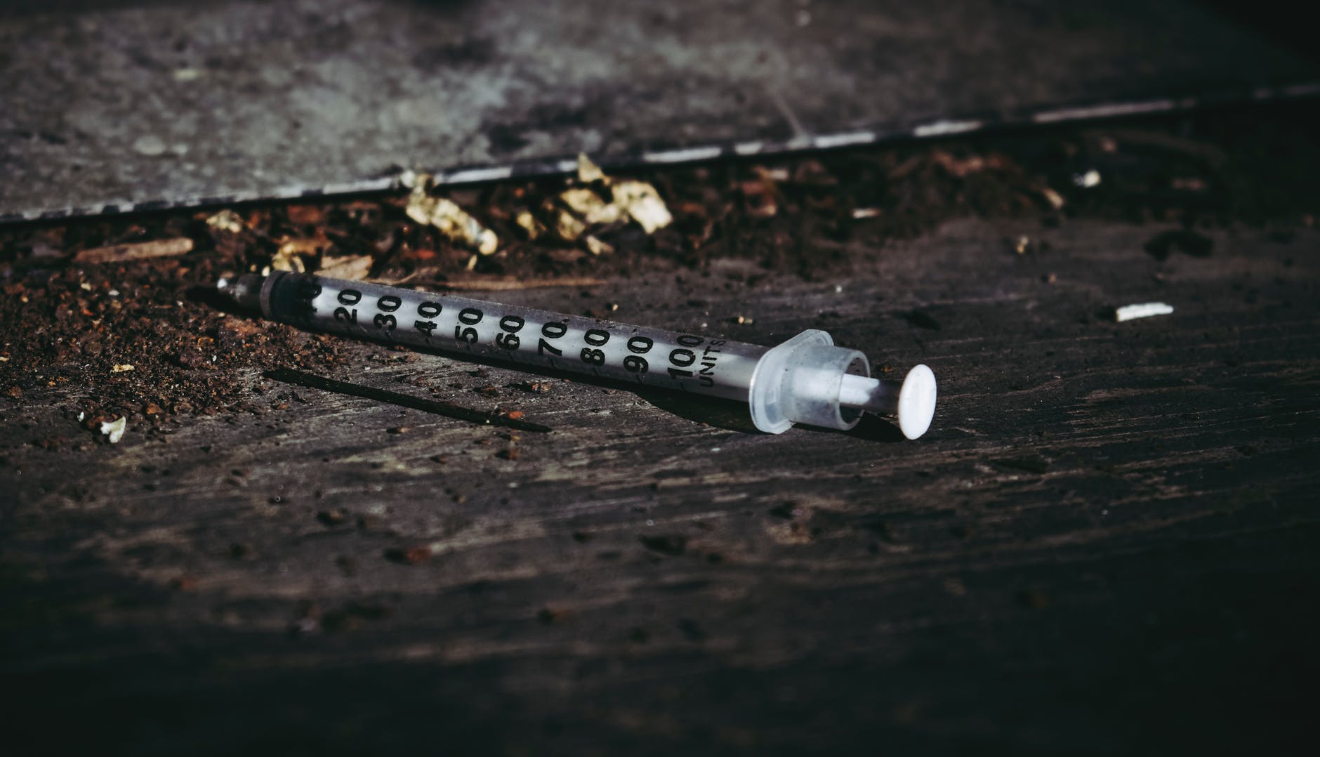 syringe on wooden floor