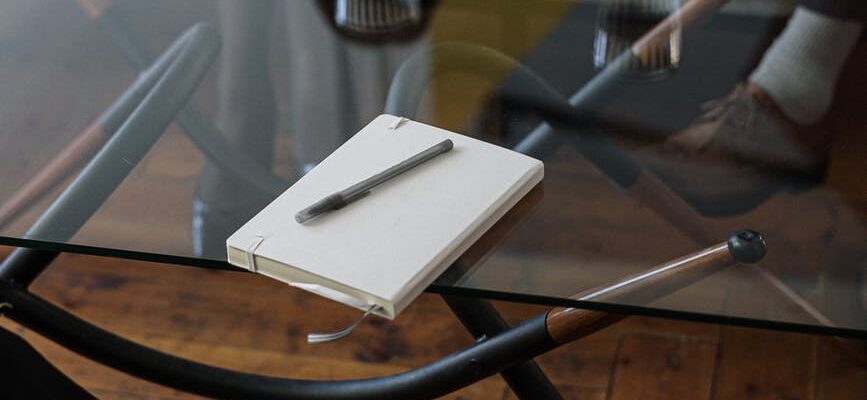 white and silver chair beside clear drinking glass on glass table