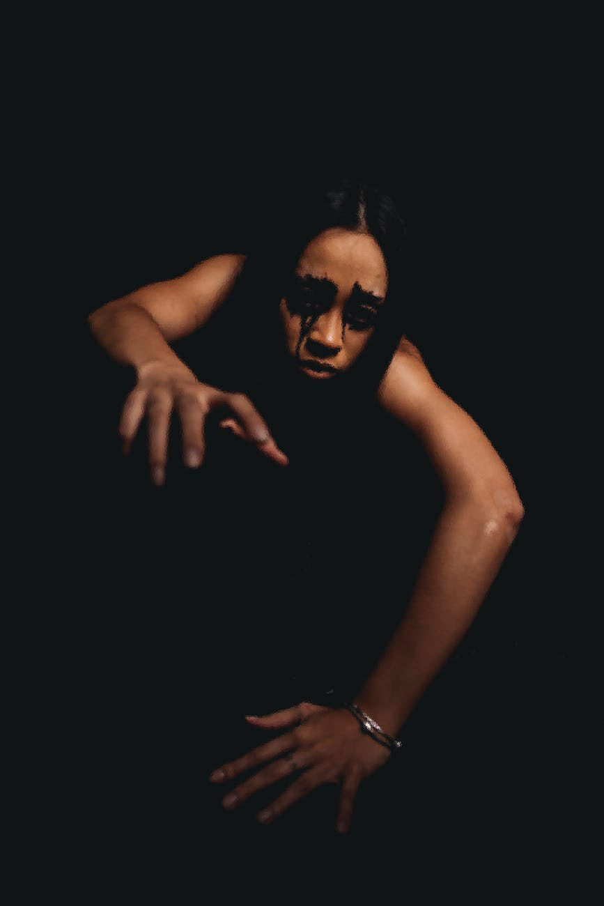 ethnic model with terrible makeup crawling at camera