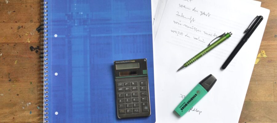 office supplies and notebook on desk