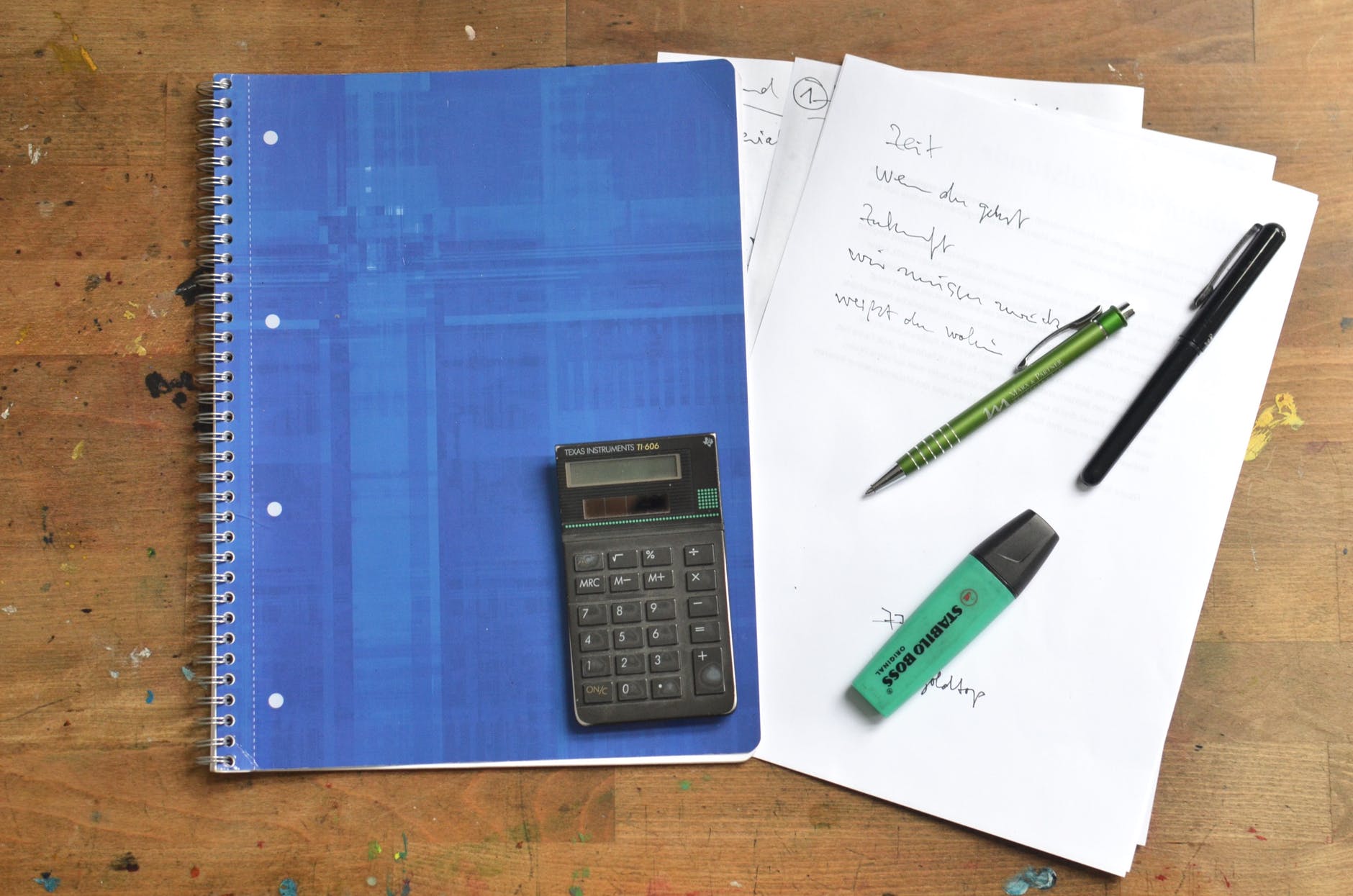 office supplies and notebook on desk