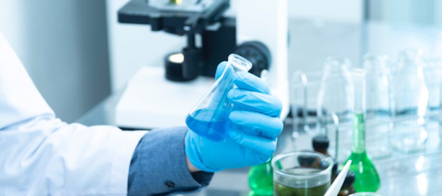 person holding laboratory flask